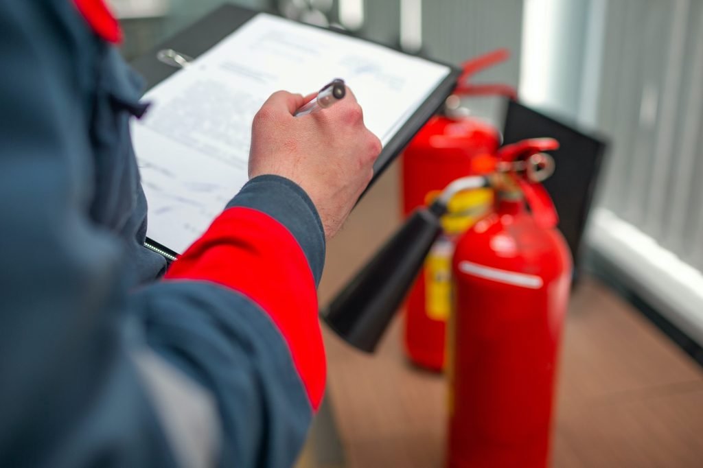 Engineer Professional are Checking A Fire Extinguisher Using Clipboard or checking Industrial fire control system,Fire Alarm controller, Fire notifier, Anti fire.System ready In the event of a fire. Fire Safety
